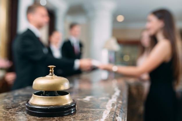 hotel reception counter with a bell