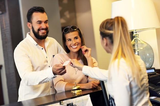 hotel manager hospitably interacting with a guest couple